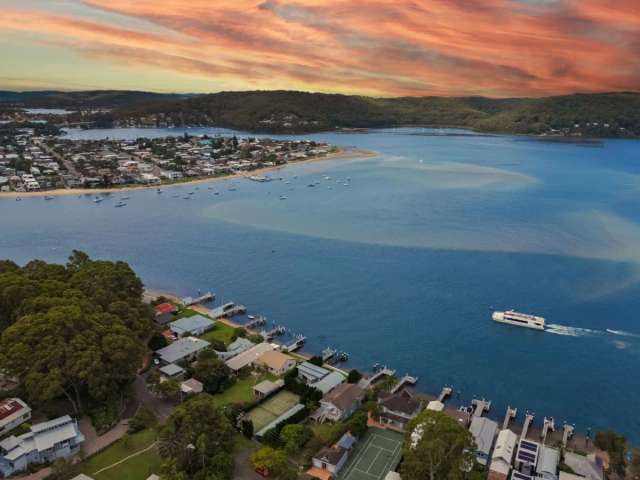 Bespoke deep waterfront haven with private beach and boatshed